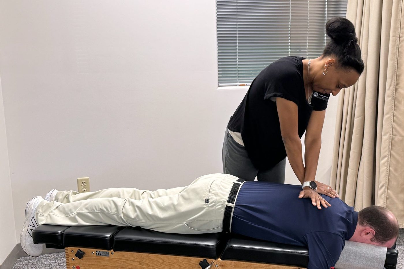 Dr. Kesia Broome performing a spinal adjustment on a patient at Sterling Ridge Orthopaedics